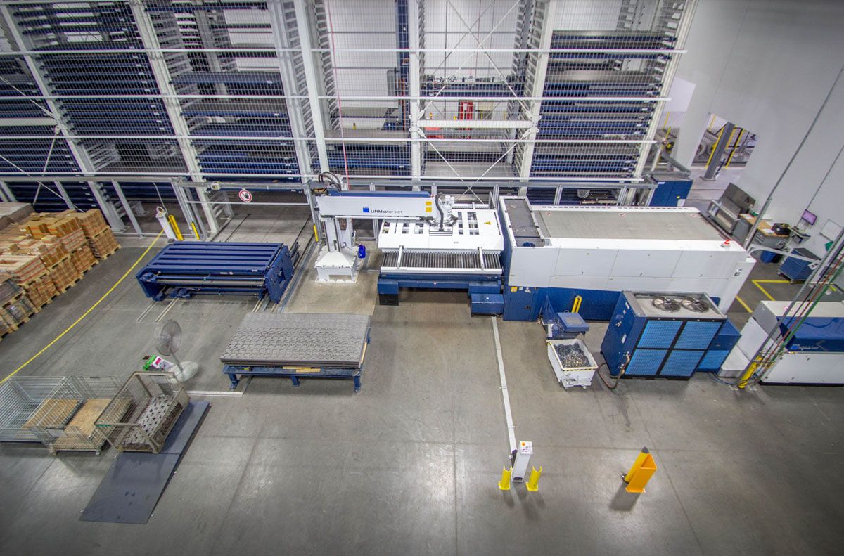 Picture: STOPA COMPACT, A double cart – consisting of a loading cart and an unloading cart in a portal design – transports sheets from the warehouse to a laser cutting machine and back to the semi-finished products.